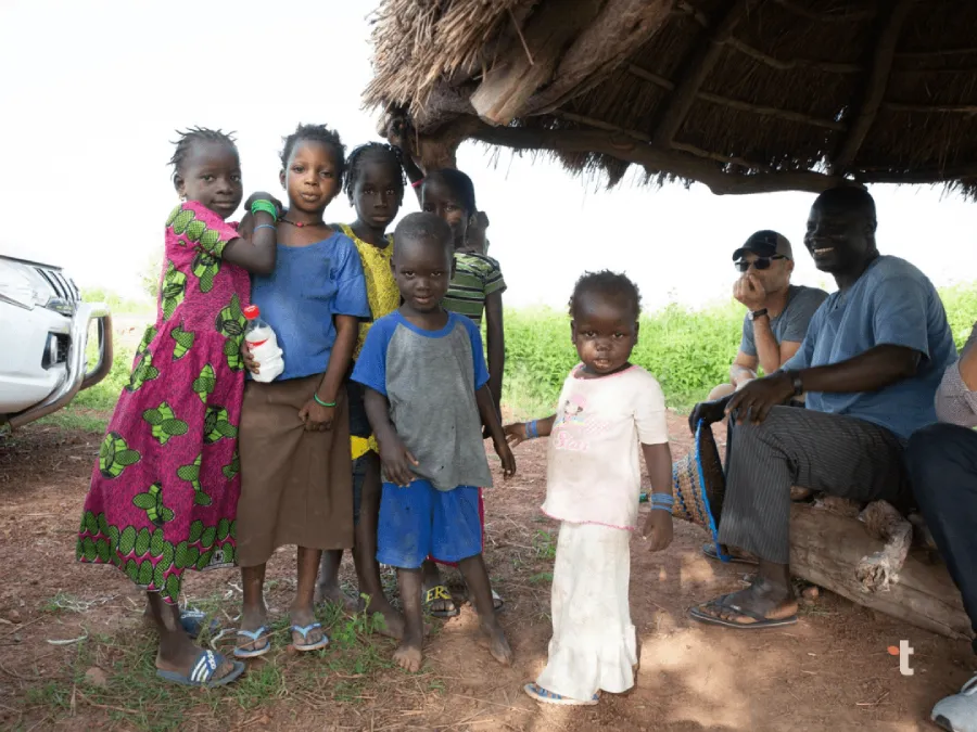 A group of children are photographed together in a village in Senegal