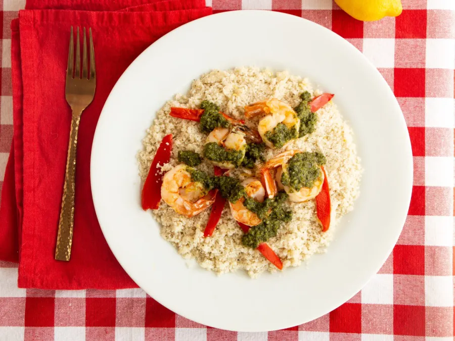 Lemony Fonio with Seared Shrimp and Pesto displayed on a red plaid cloth