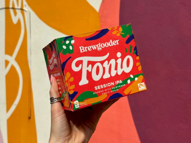 A case of Brewgooder Fonio Session IPA is help up by a hand