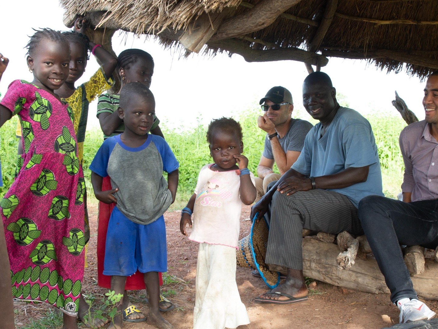 A group of children pose for a photo in a West African village where fonio is produced.