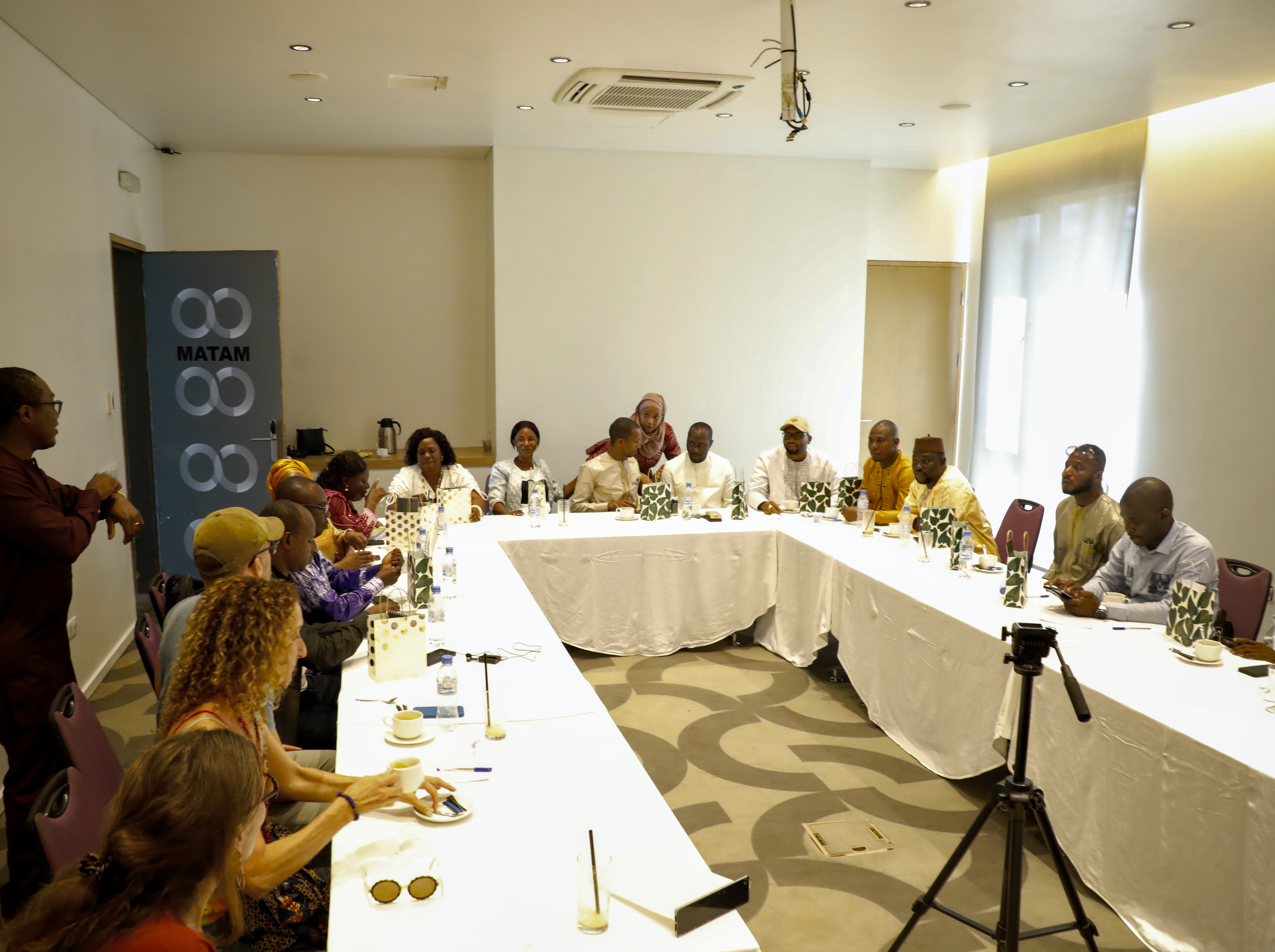 A group of local decision makers meet in a conference room in Guinea