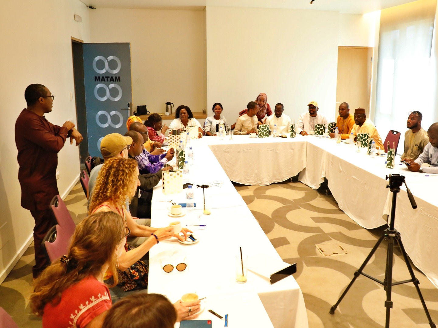 A group of local decision makers meet in a conference room in Guinea