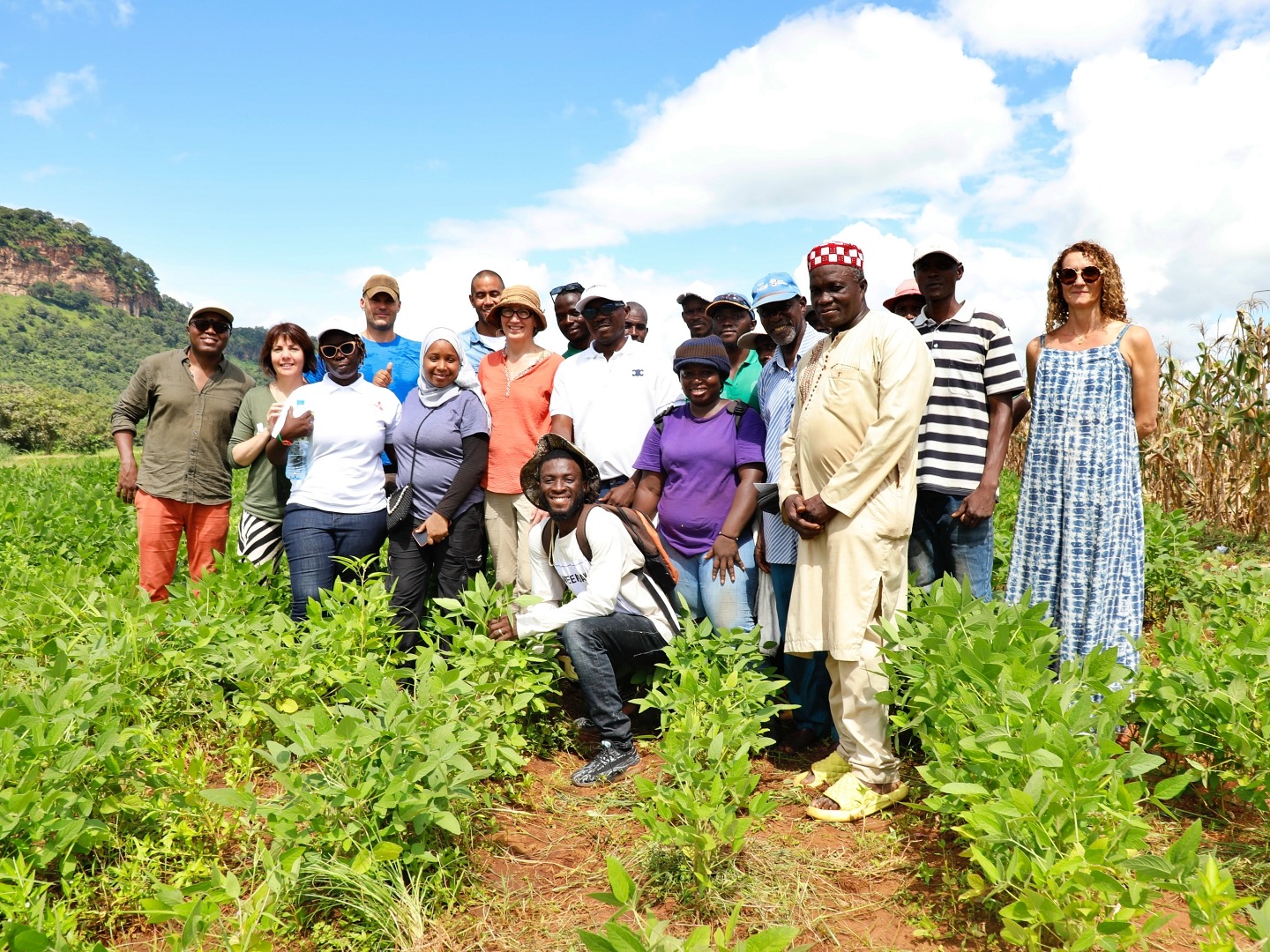 A group of men and women pose for a photo on a farm in Guinea, West Africa